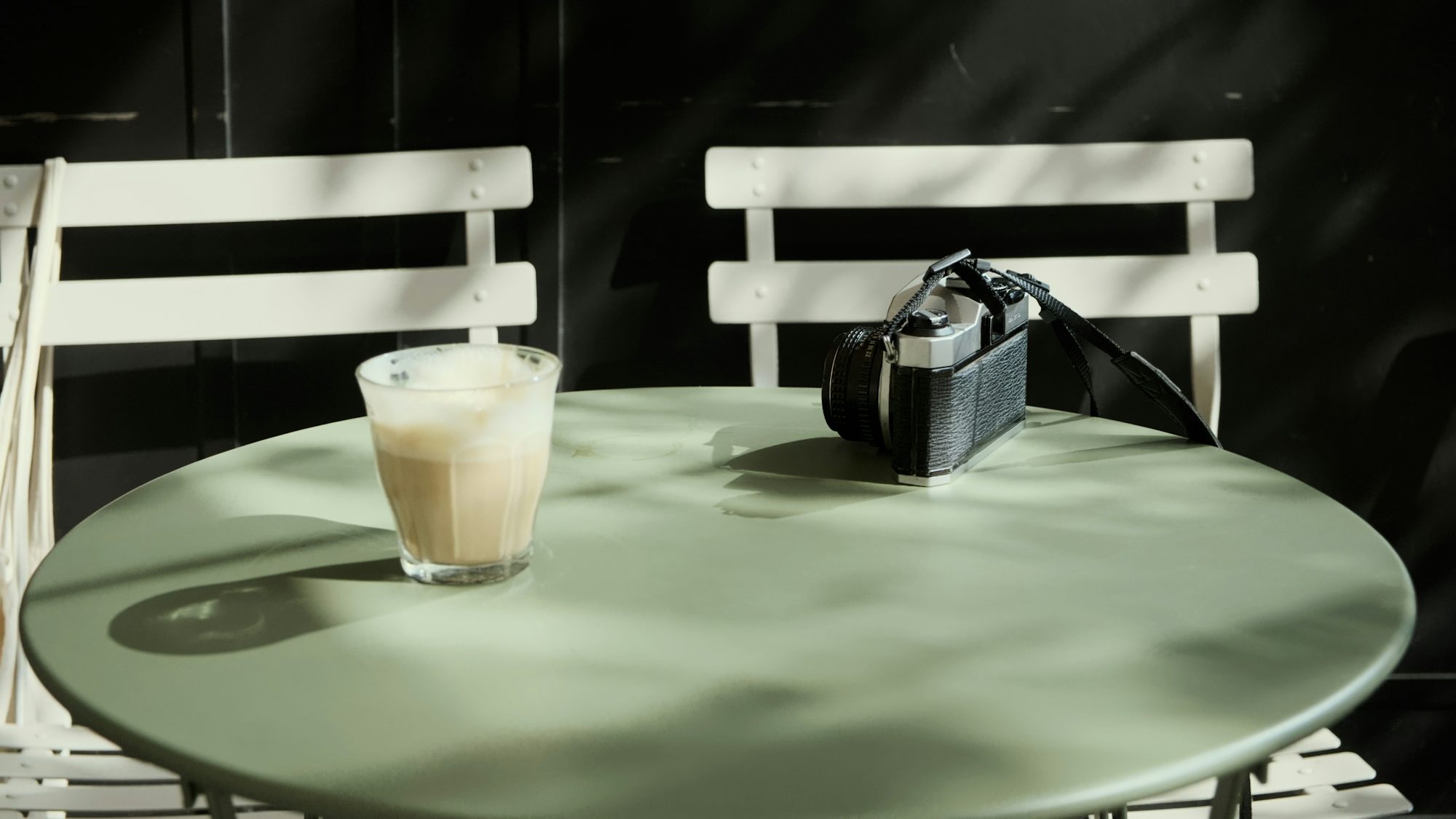 Outdoor café table in Tel Aviv with coffee and pastry